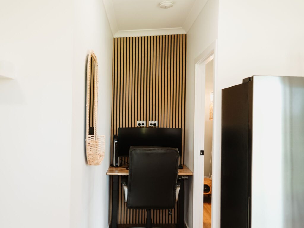 Sleek and modern office area inside a backyard office pod with desk, chair, and natural light.