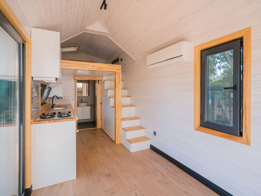 Interior of a modern granny flat in Bundaberg highlighting an open-plan kitchen and living area with contemporary design.