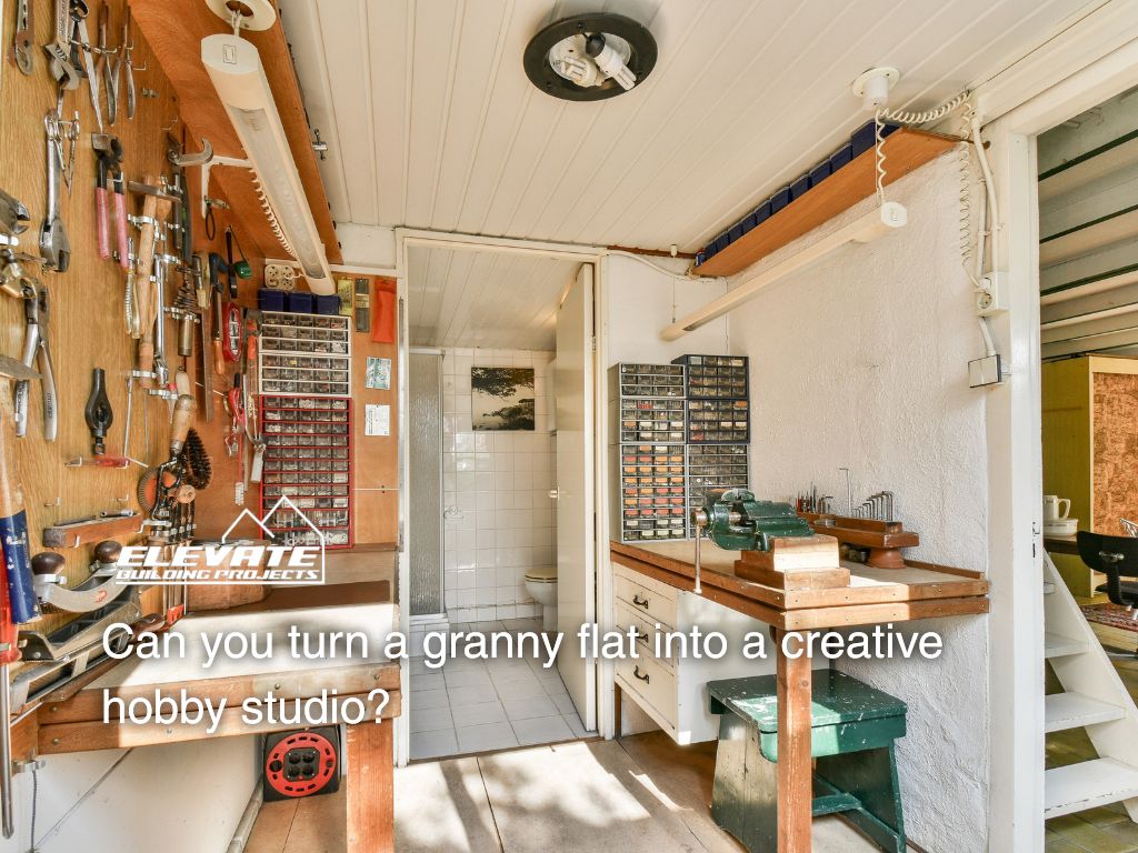 Interior of a granny flat converted into a creative hobby studio with tools, workbench, and organised storage.